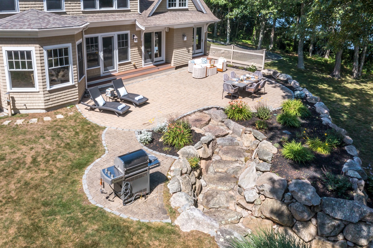 A full layout of lakeside living—grill, firepit, seating, and the water just steps away.