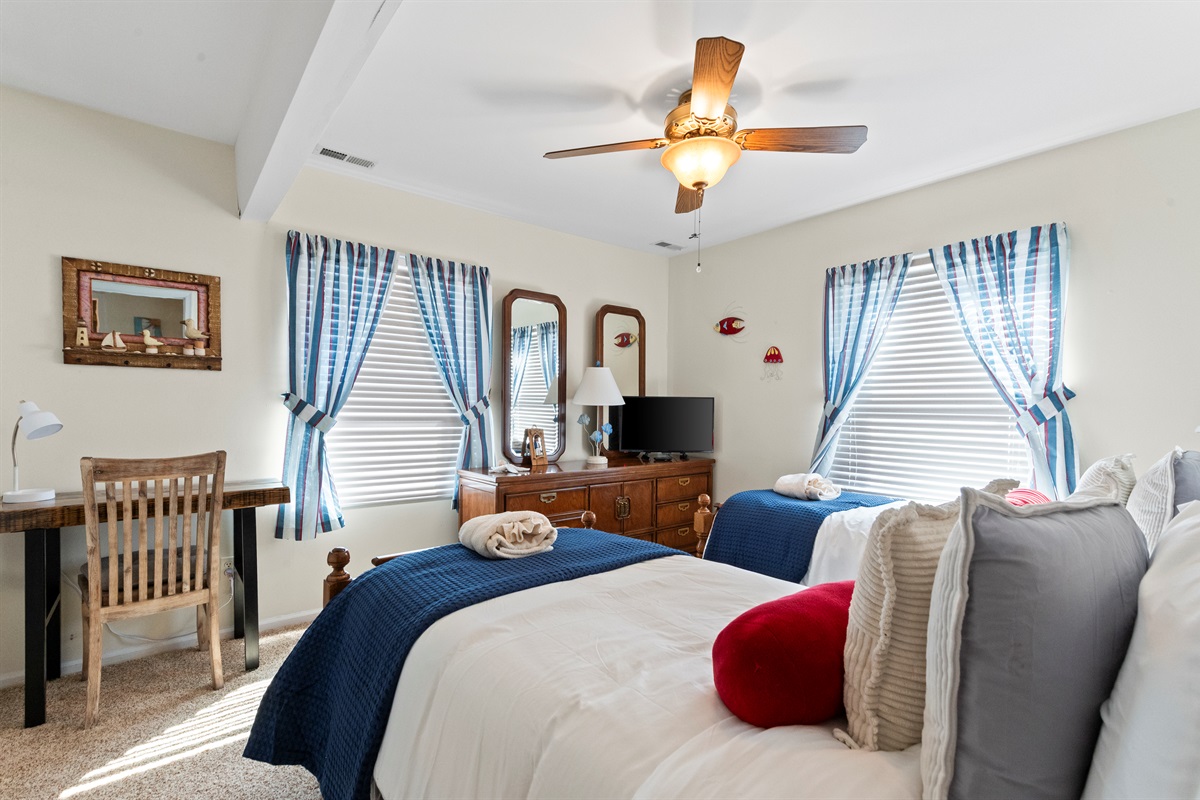Bedroom 3 with Twins: Bright, nautical-themed escape with two beds and sunny views for perfect relaxation!