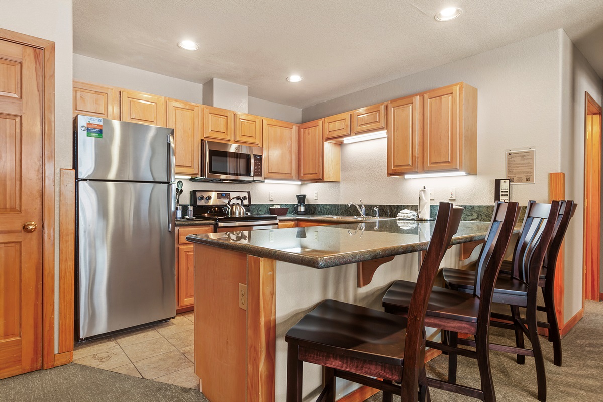 Full size kitchen with extra bar seating for 4
