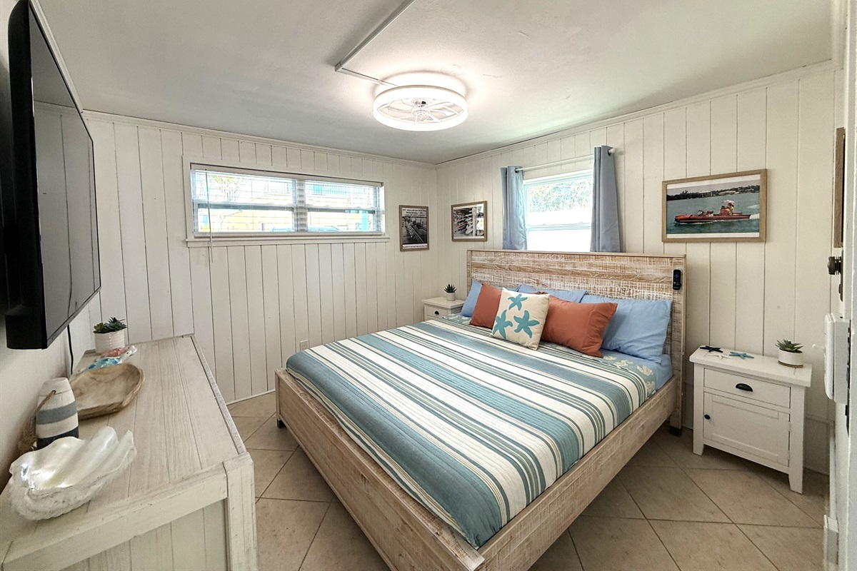 Primary Bedroom with King Bed & Retro Photos & 65" TV