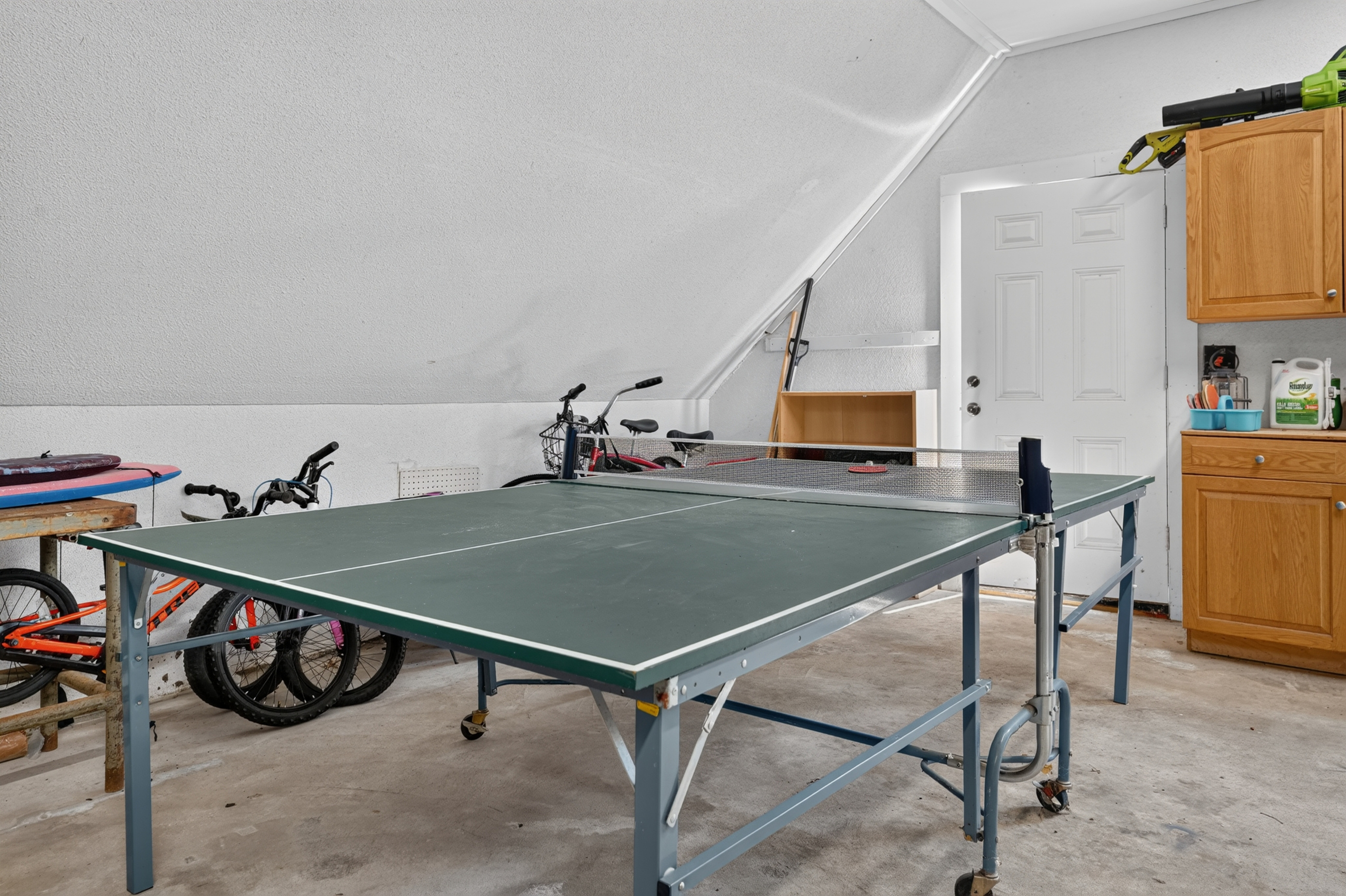 Game area featuring a ping pong table for hours of friendly competition.
