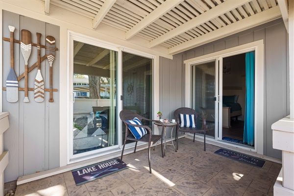 Tucked just outside the master bedroom, this charming covered patio offers a cozy spot to sip your morning coffee or unwind in the evening. With cushioned seating, nautical décor, and welcoming touches, it’s your own peaceful corner of lake life.