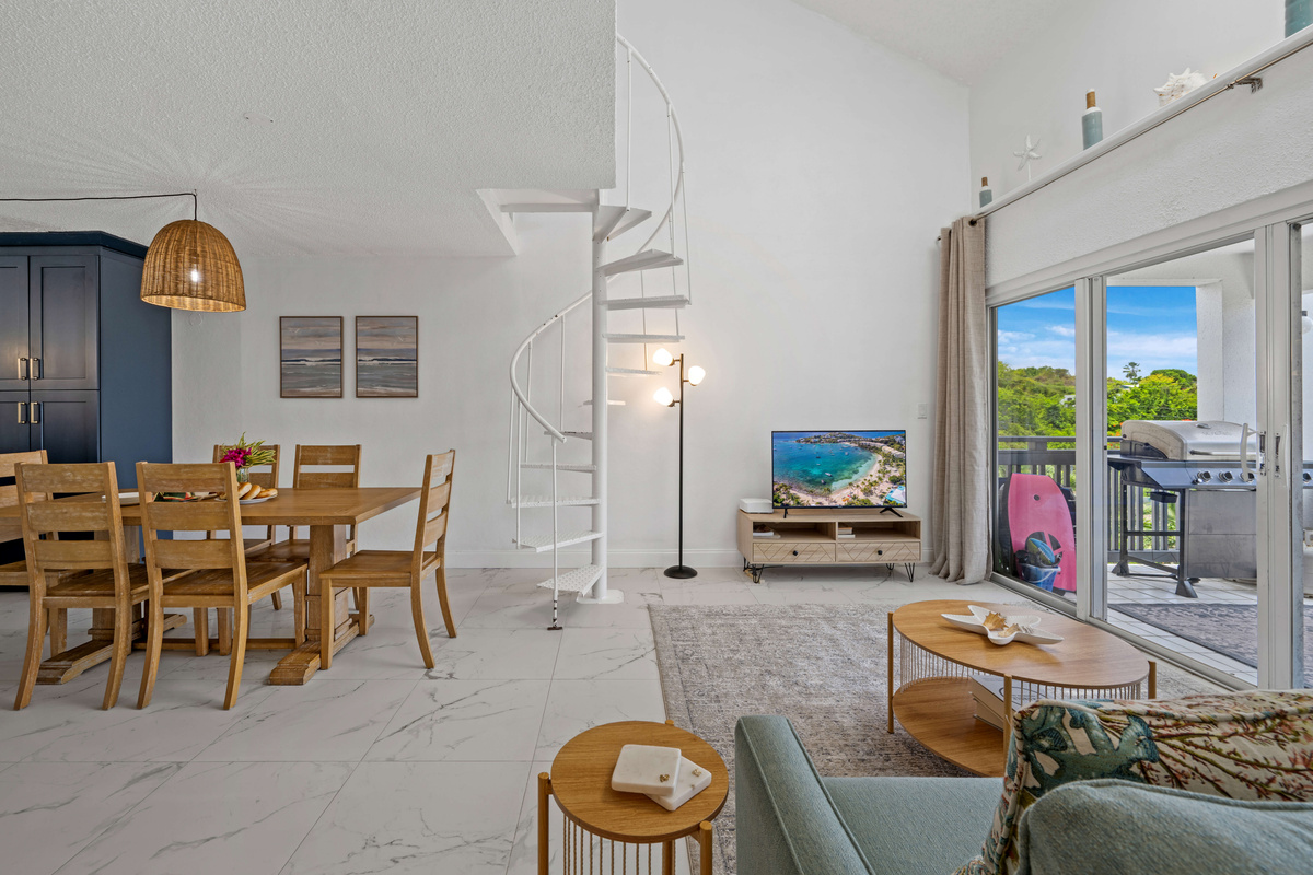 Relax in the spacious living area while enjoying beautiful views of the private deck.