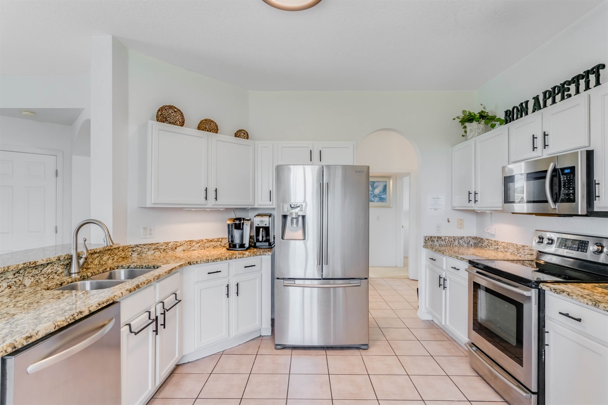 Modern kitchen with granite counters and SS applainces.