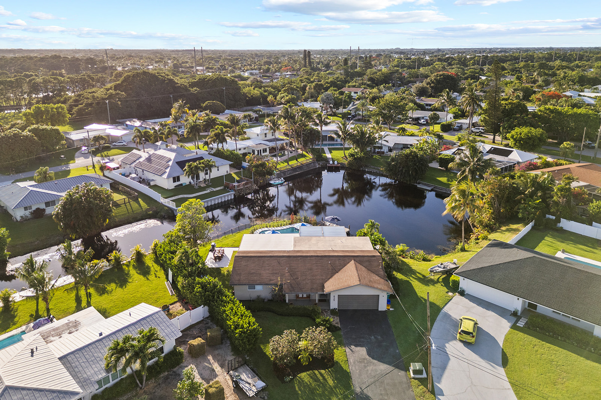 Enjoy a bird's-eye view of the resort-style pool deck designed for relaxation, dining, and outdoor entertaining.