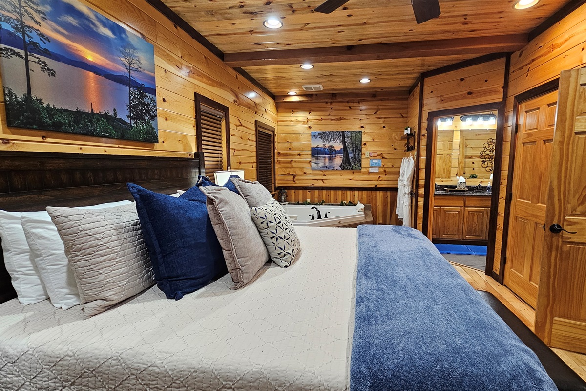 Cozy king bedroom featuring a relaxing jacuzzi tub and easy access to the en‑suite bath.