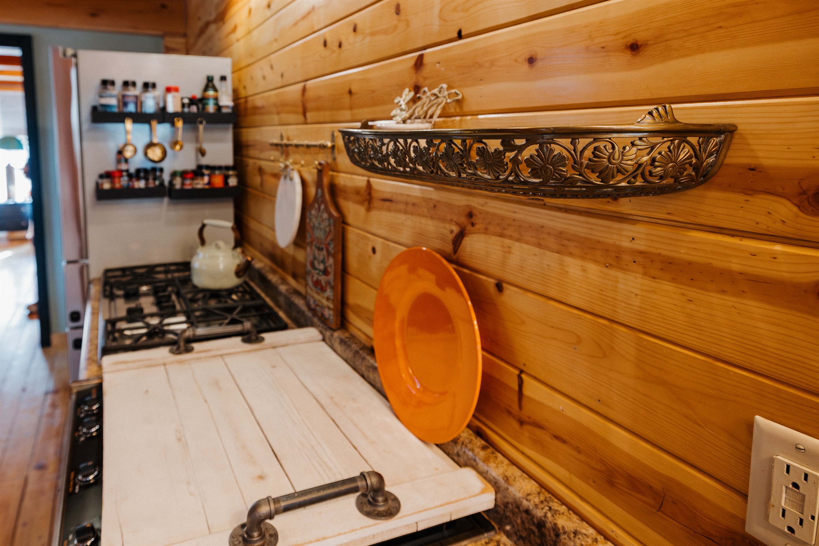 Poppywood Pines blends history and design with one-of-a-kind details—like a vintage brass shelf reclaimed from an old train—adding authentic character to this thoughtfully curated A-frame cabin in the White Mountains.