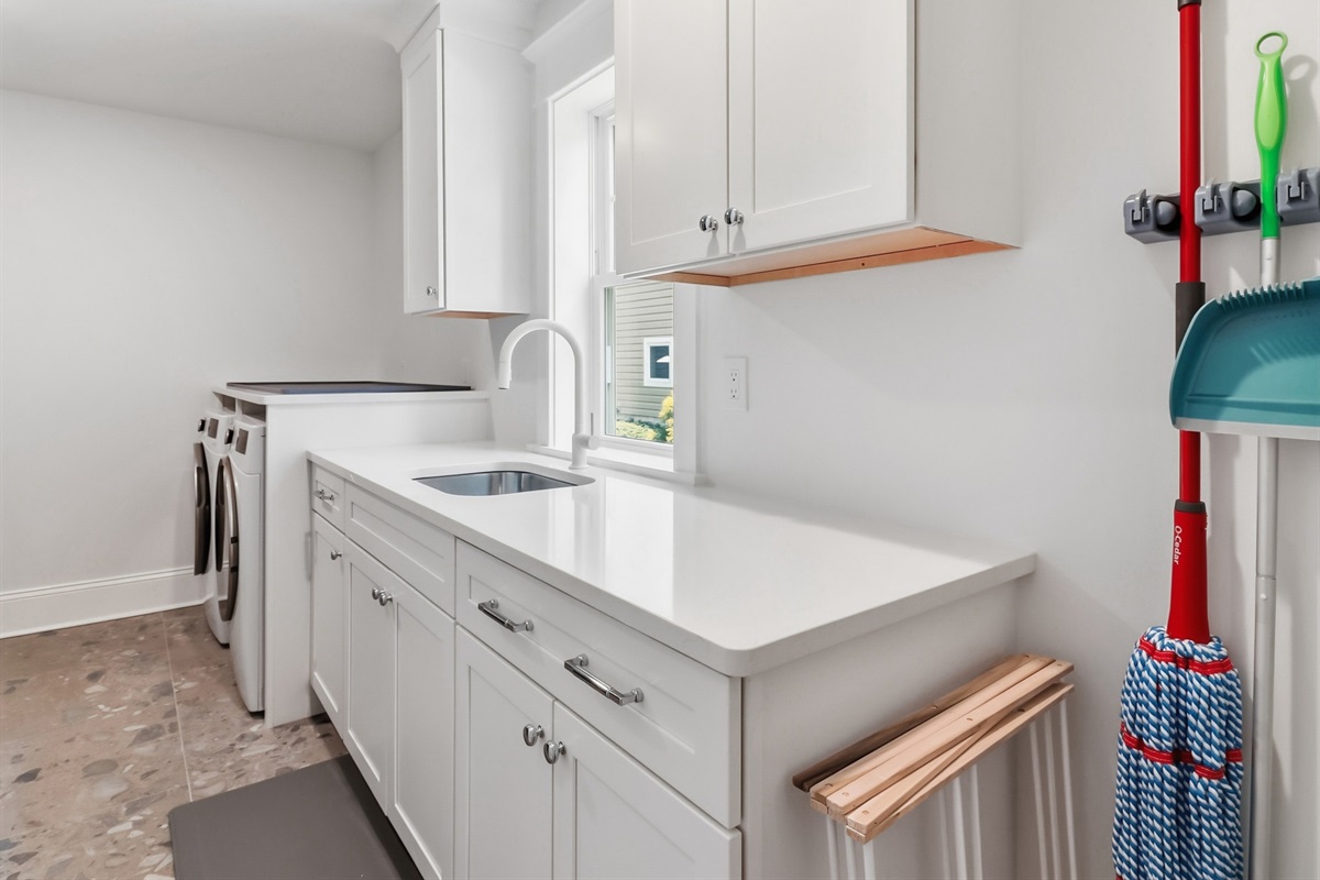 Washer and dryer area with cleaning supplies