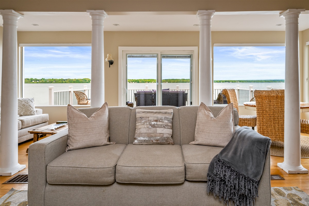 Bright and airy living space with panoramic lake views and direct access to the waterfront deck 🌊🛋️☀️