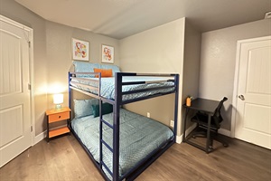 Our spacious room is perfect for groups, featuring a double-sized bunk bed, an additional double bed, and a smart TV for everyone's enjoyment.