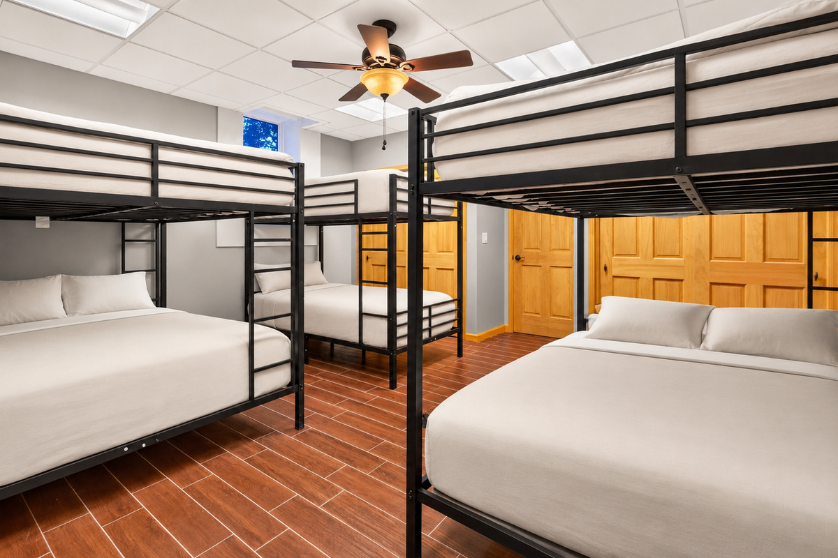 Bunk room with multiple metal-framed beds
