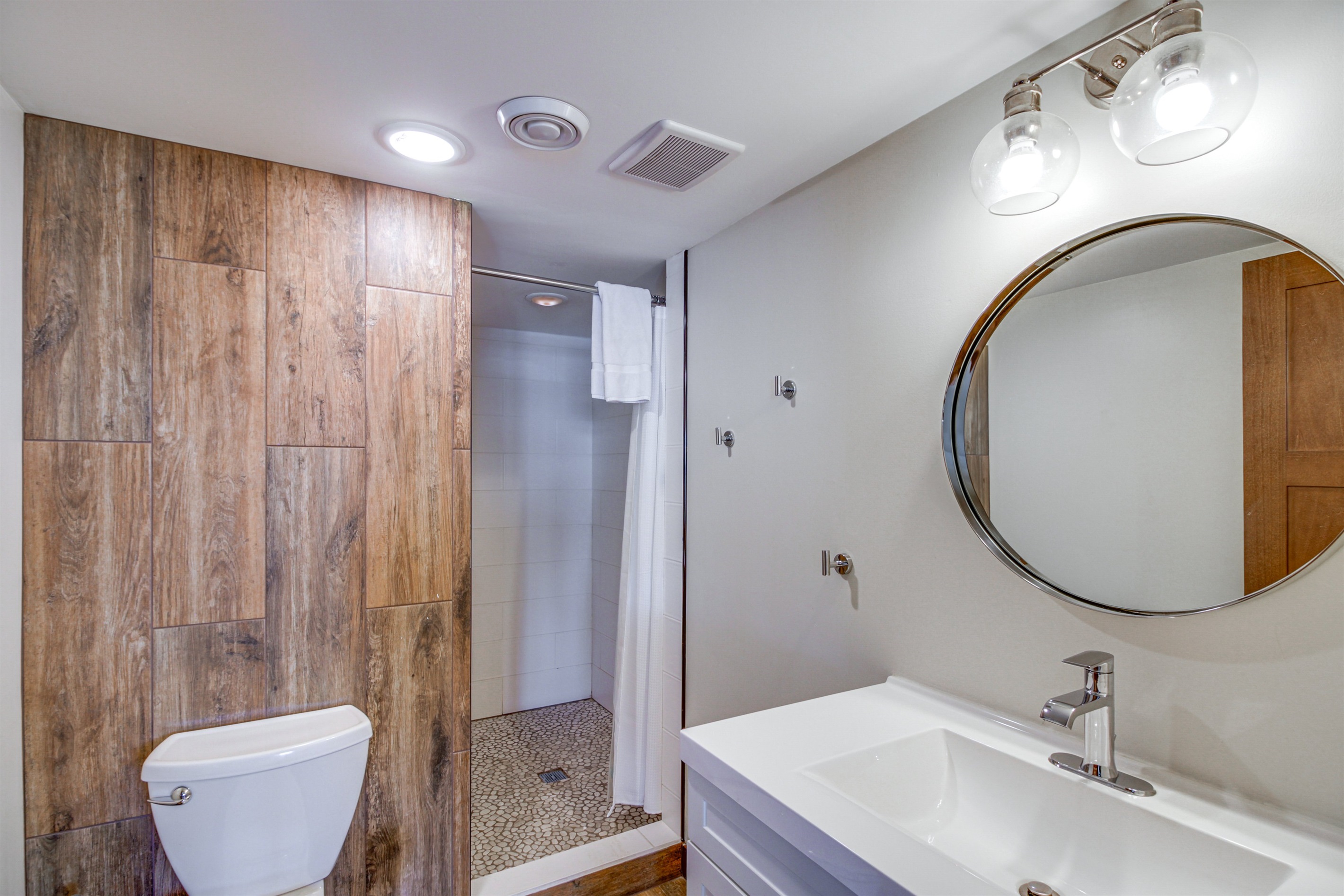 Updated bathroom with walk-in shower and modern vanity