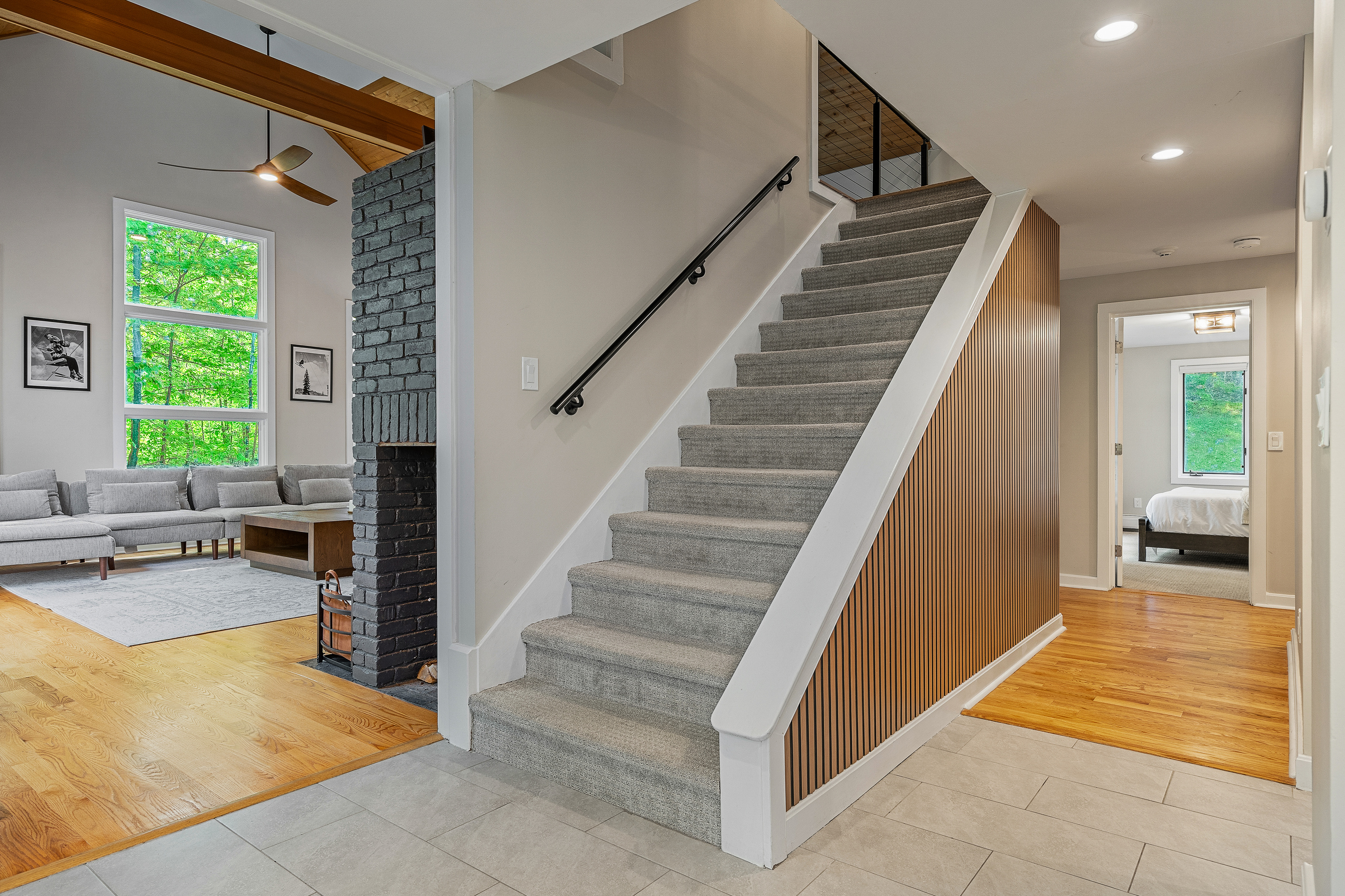 Staircase linking the great room to the upstairs bedrooms at this Winhall, Vermont ski house