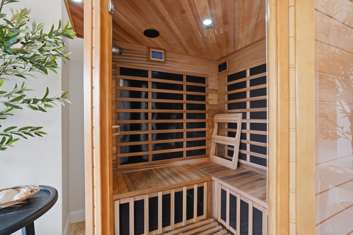 Unwind and recharge in the private infrared sauna, thoughtfully designed with warm wood finishes and spacious bench seating. 