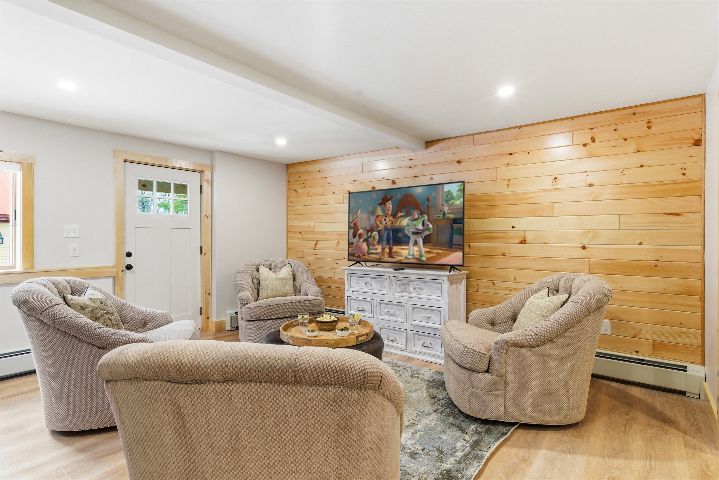 Movie night in style: gather in our cozy secondary lounge, featuring plush swivel seating and a large-screen TV.