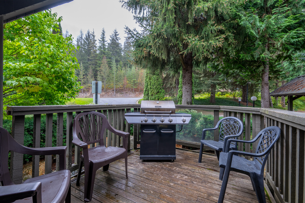 Private deck with a BBQ and forest view. In winter it holds the Ski-Key locking ski and snowboard racks; in summer you can lock bikes here.
