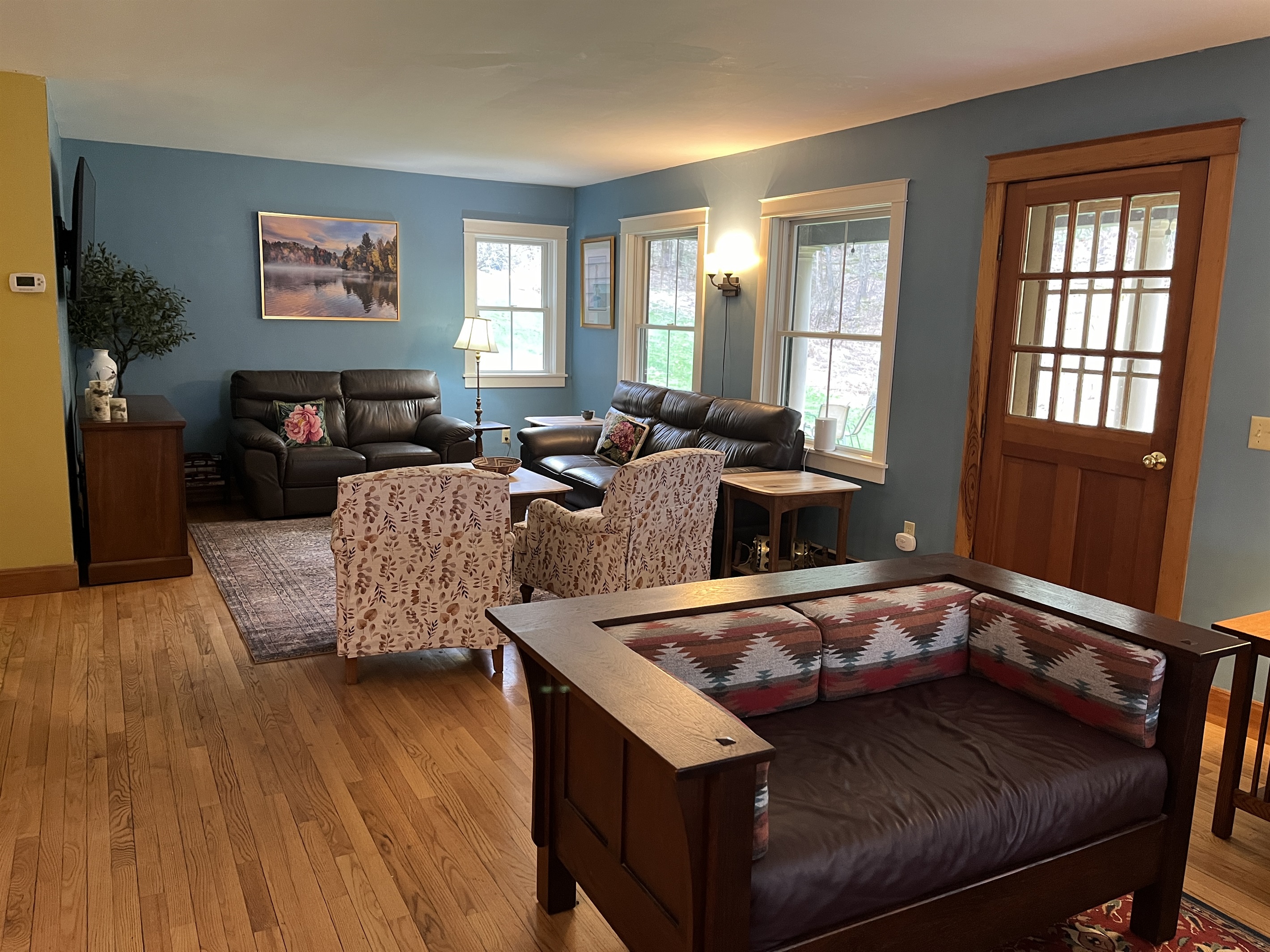 Living area into TV area with porch door in the middle