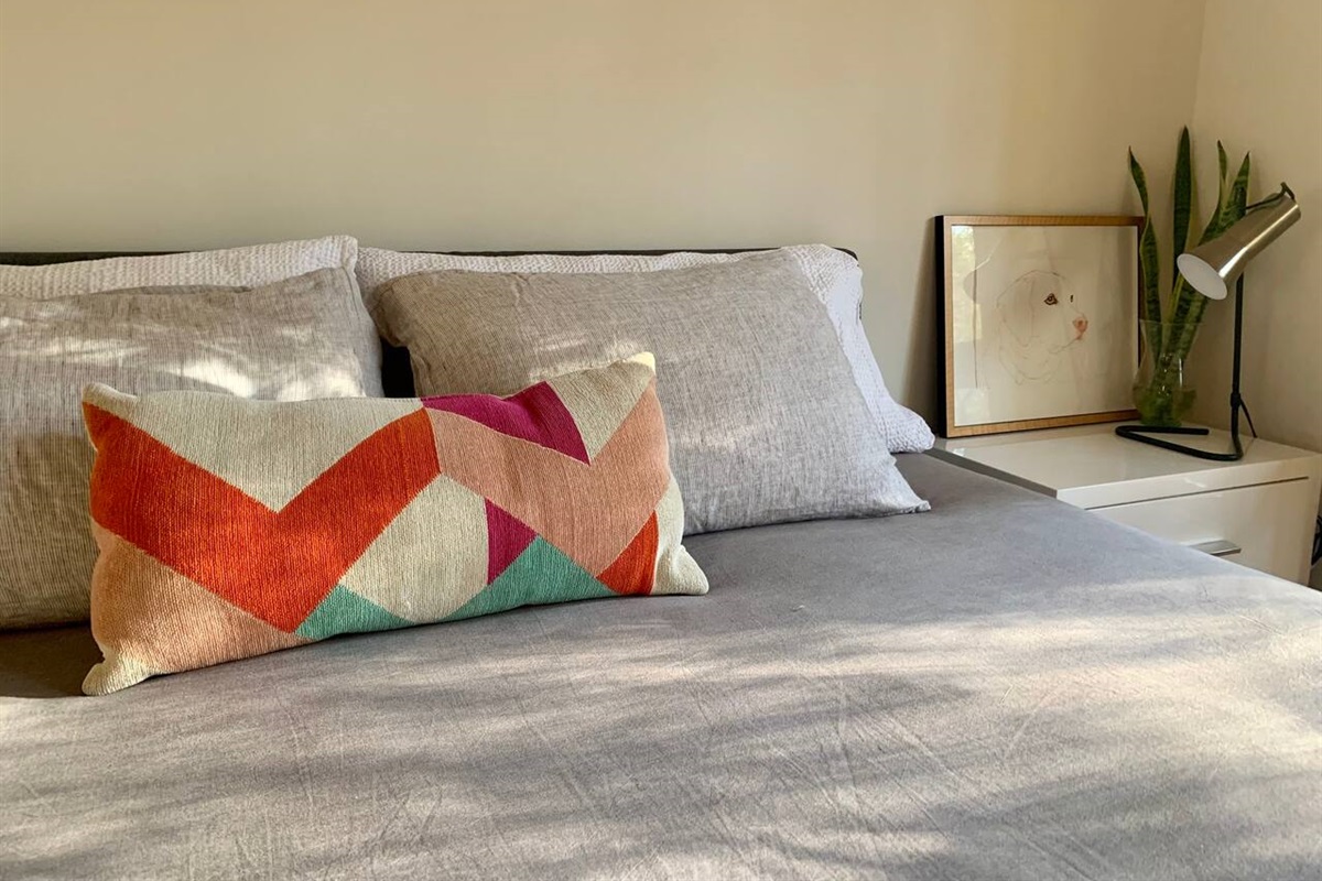 Crisp bedding, a pop of color, and just the right number of pillows &mdash; this bed does not disappoint.