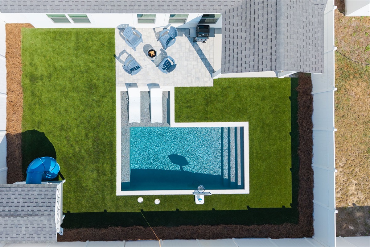 Backyard Aerial.  Kids Playhouse, private pool (heating optional) with sundeck, Adirondack chairs, wood fire pit, gas grill and private outdoor shower.