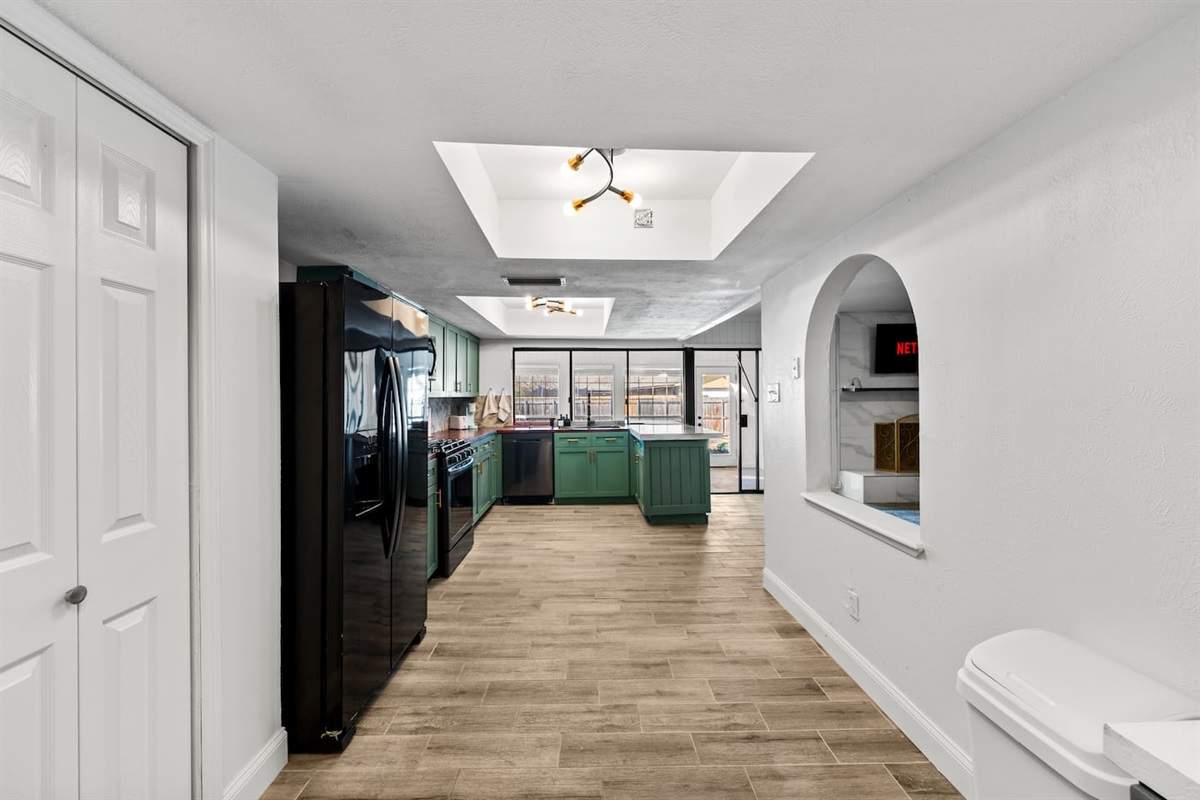 Cook and connect in this fully equipped kitchen with granite countertops, large island, and stainless steel appliances.