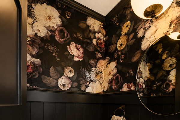 Make a statement with this dramatic main floor half bath. Rich floral wallpaper, moody tones, and elegant finishes create a memorable designer space that guests love. Conveniently located on the main floor, it's both beautiful and functional.