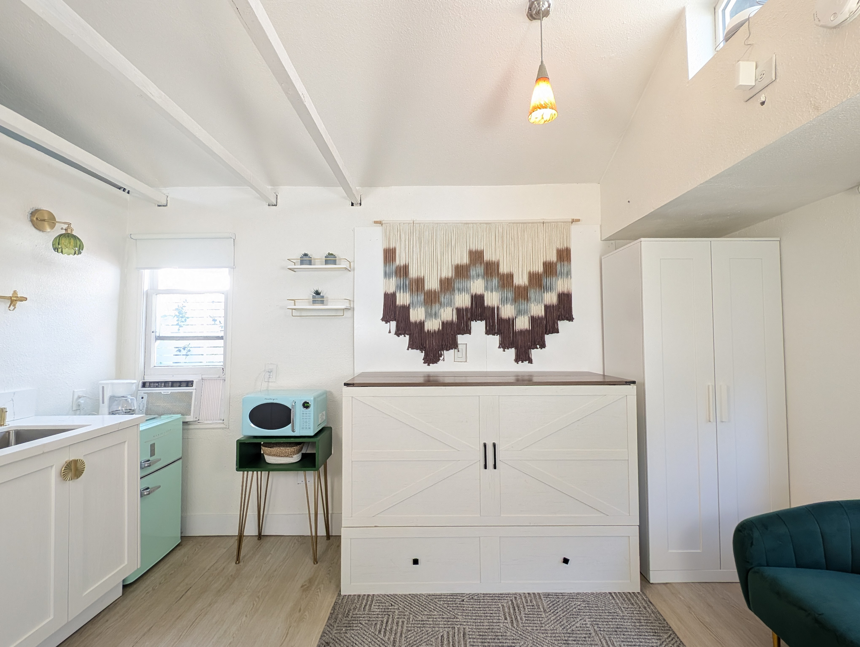 Queen Murphy bed folds away to maximize space.