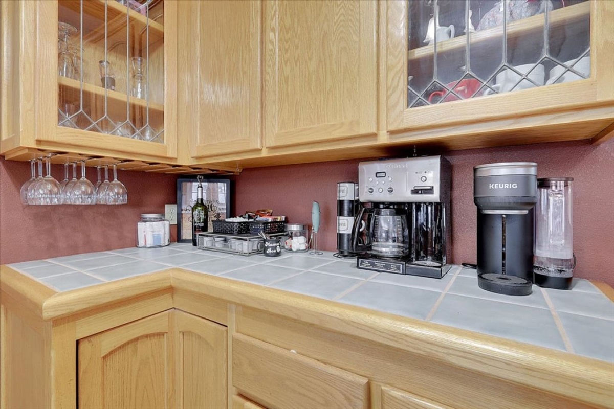 Coffee, tea, and wine station with extra cabinet storage beside the dining area.
