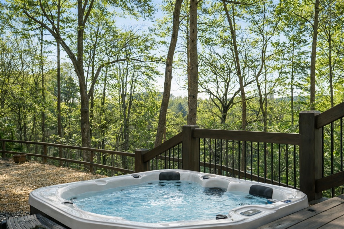 Twilight at the cabin: hot tub bubbling, lights glowing, and nothing but nature around you.