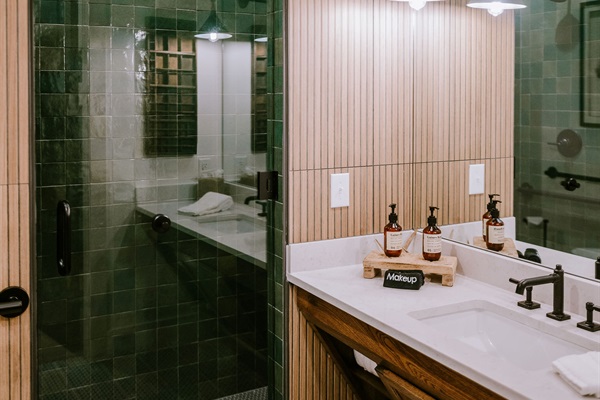 The Homestead Suite's ADA-accessible vanity &mdash; open base for wheelchair roll-up, accessible fixtures, and curated modern Western design.