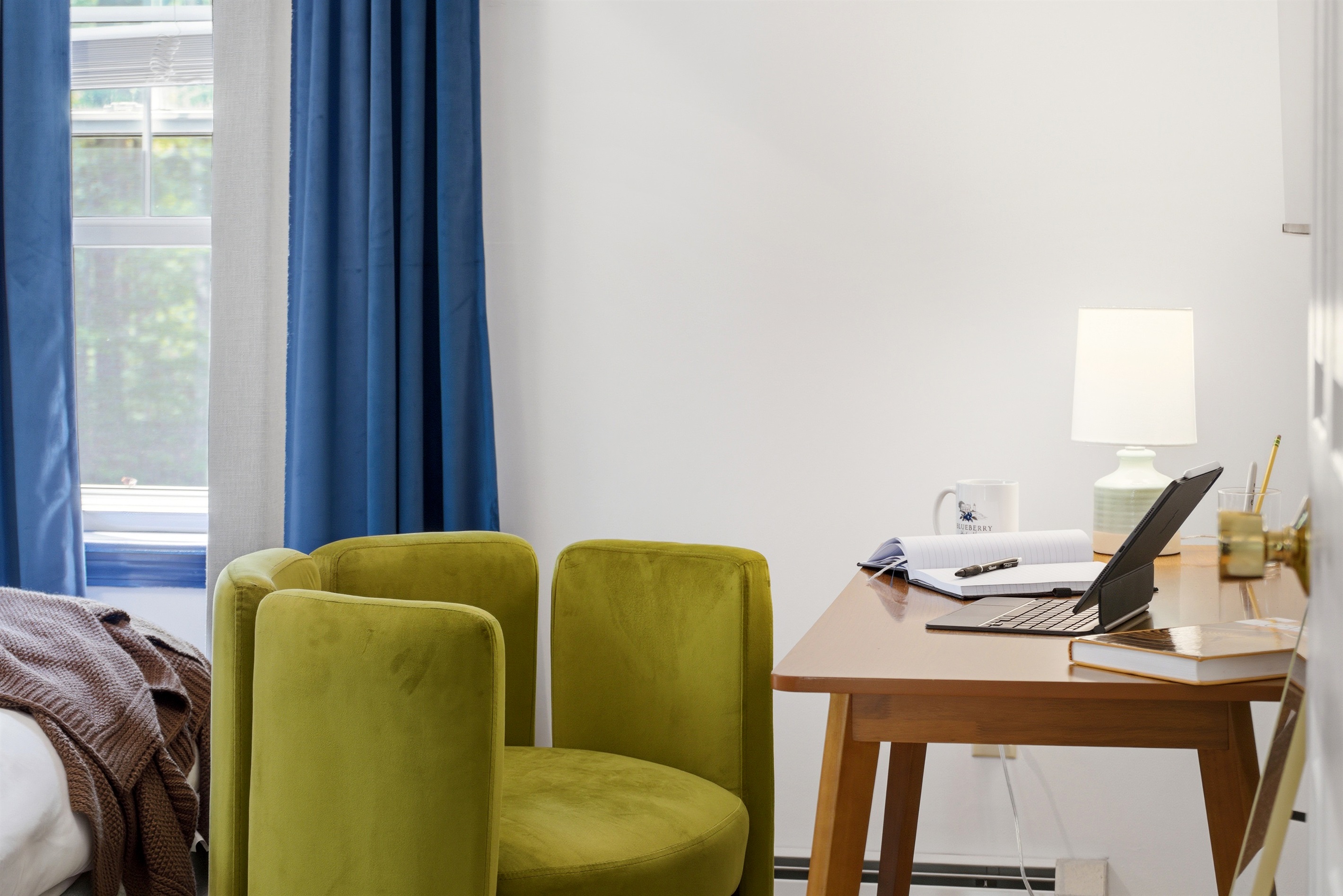 A cozy bedroom featuring a dedicated workspace, thoughtfully designed for comfort and productivity in a peaceful setting.