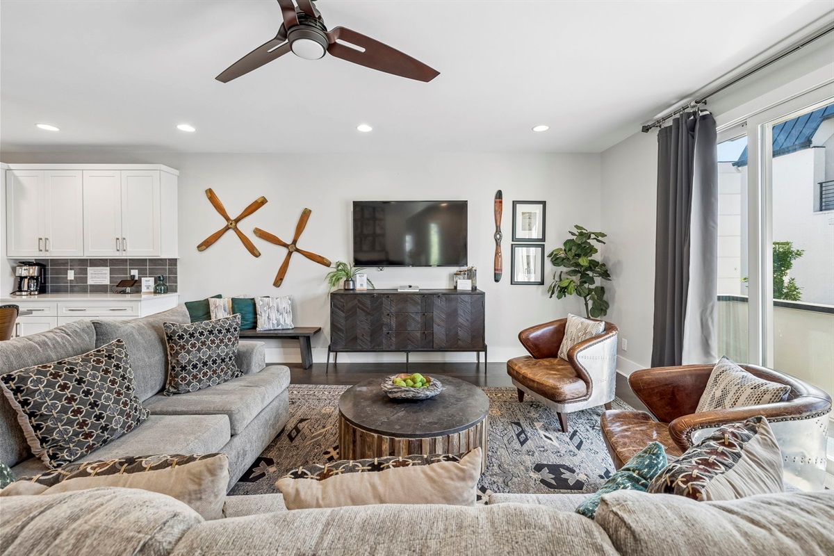 Rich leather club chairs paired with a rustic wood coffee table create an inviting nook - Decorative tray with sparkling water & greenery adds a polished, welcoming touch - Layered textures & industrial modern vibes make this a perfect spot to unwind