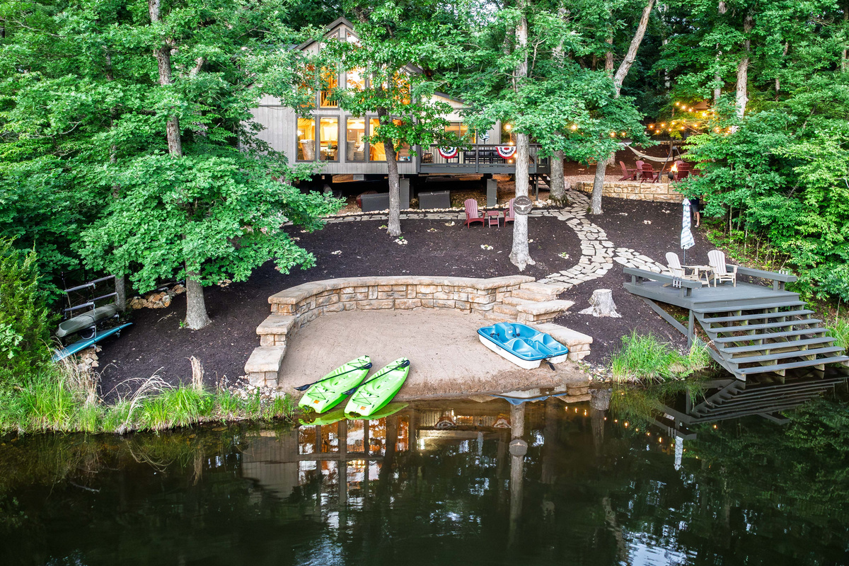 Private beach, dock, kayaks, and peaceful lakefront views.