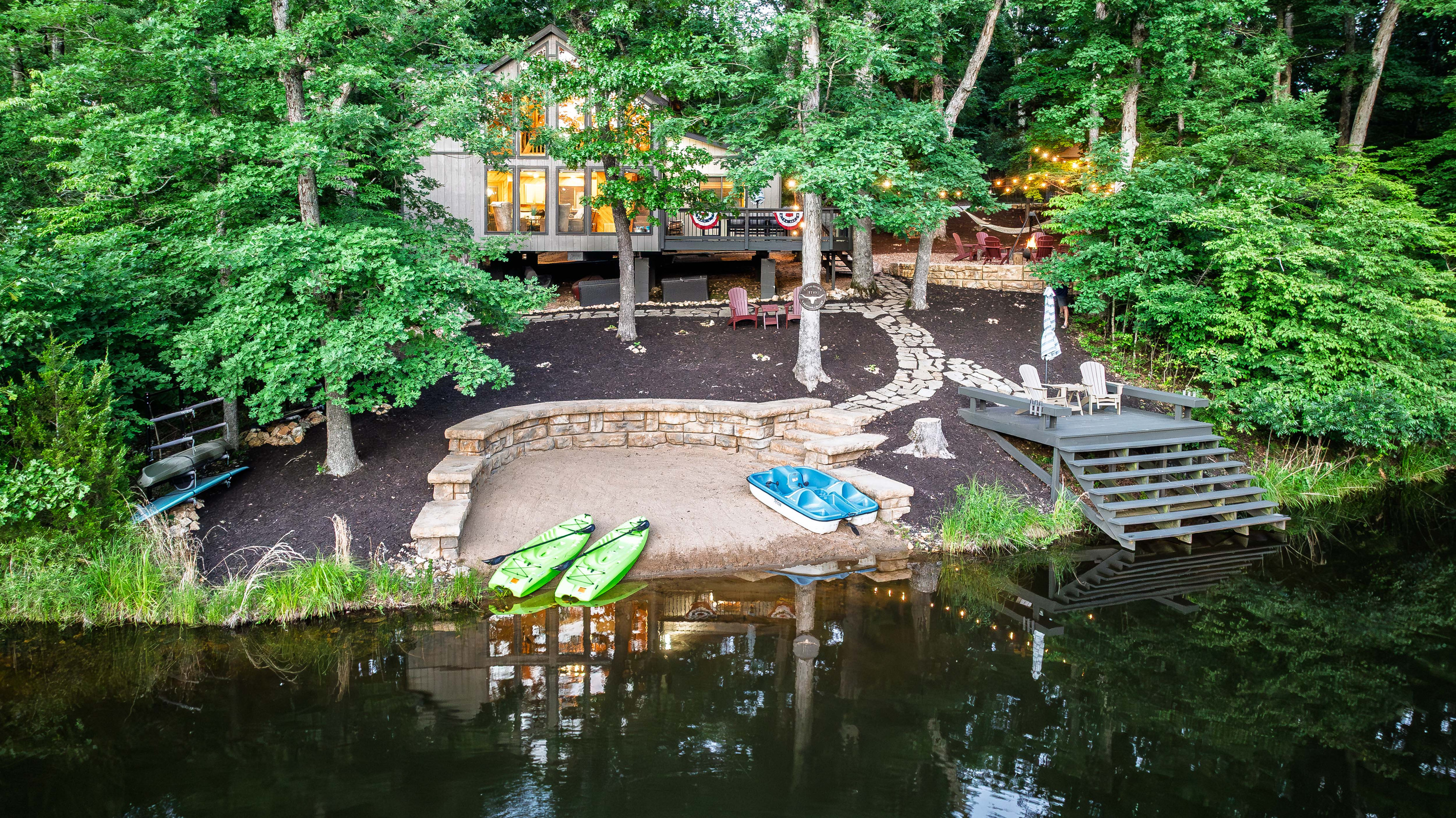 Private beach, dock, kayaks, and peaceful lakefront views.