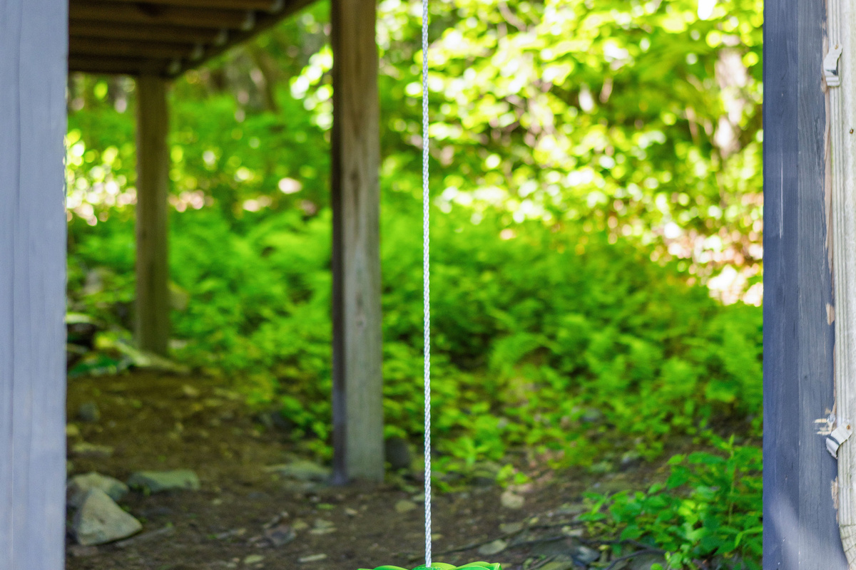 Simple disc swing under the porch—easy, classic fun for kids