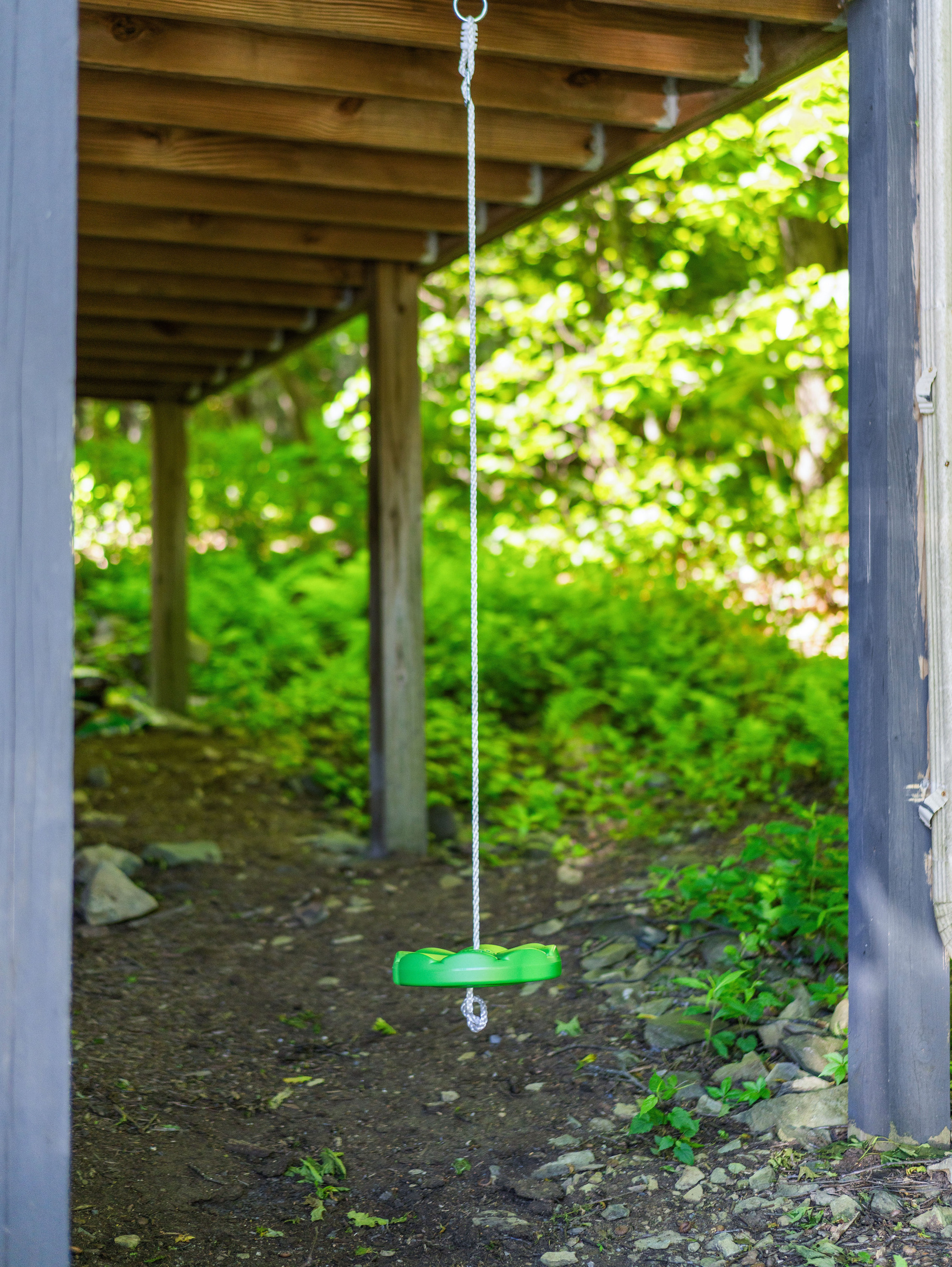 Simple disc swing under the porch—easy, classic fun for kids