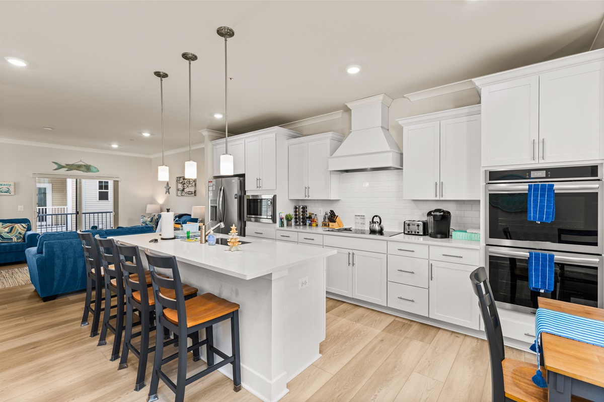 Kitchen island with plenty of space to prepare meals or use laptops.