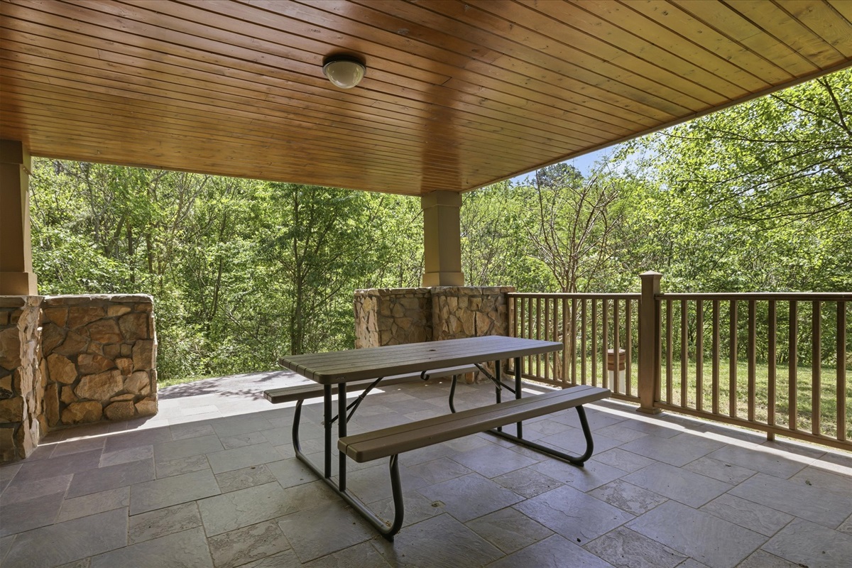 Gather on the covered porch with a picnic table ready for meals, conversation, or just unwinding while you take in the peaceful surroundings.