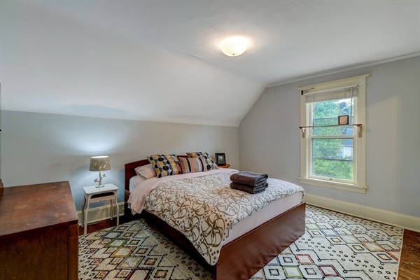 Cozy queen bed in the front bedroom.