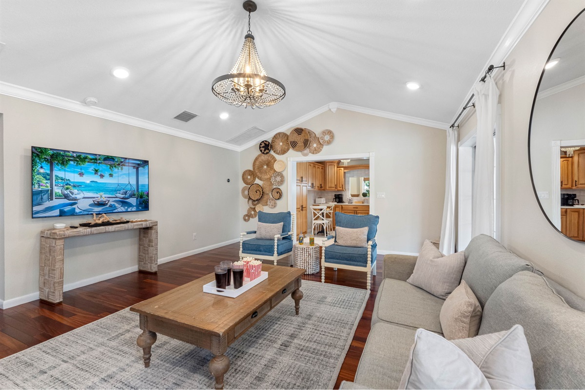 This inviting living room features a cozy fireplace framed with crisp white shiplap, accented by warm hardwood floors and soft neutral décor.