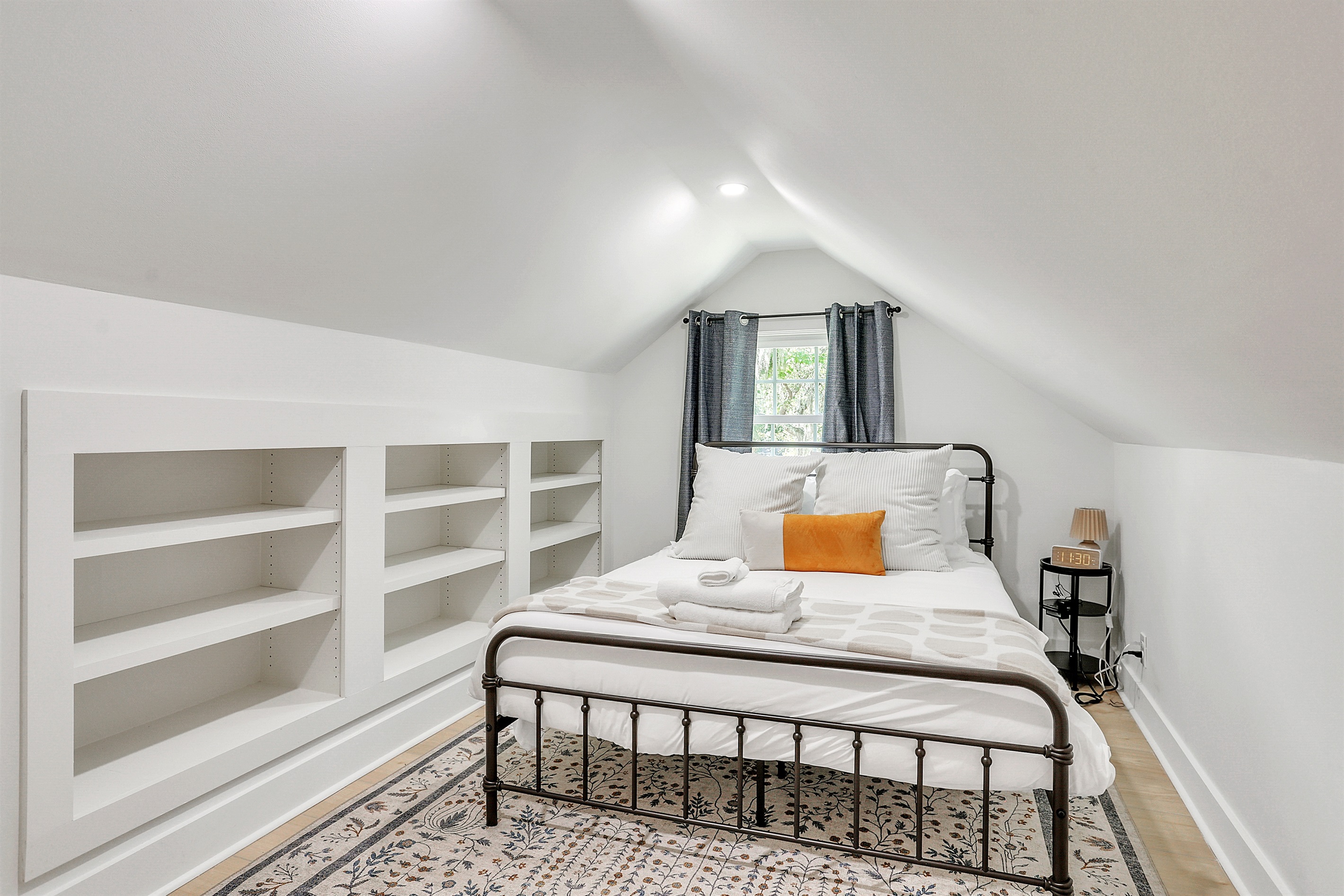 A peaceful retreat with soft linens, warm lighting, and all the comfort you need for a good night’s sleep.