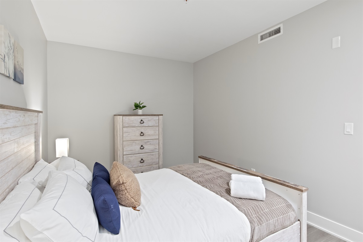 This serene guest room offers comfort and charm with a plush bed, stylish wood furnishings, and ample closet space — ideal for your Finger Lakes getaway.