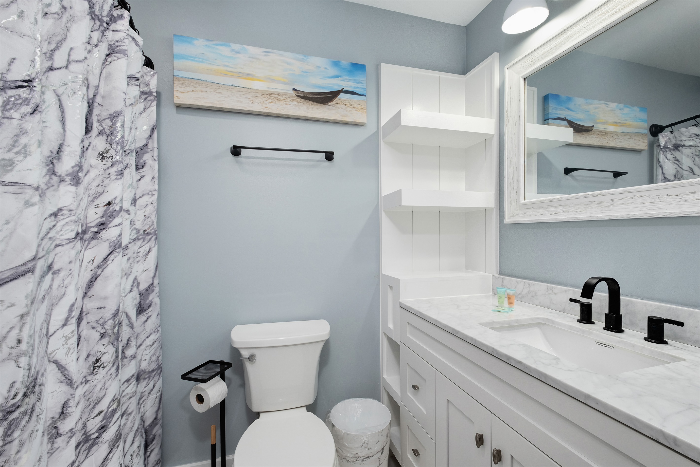 reshen up in the modern bathroom featuring coastal decor and elegant finishes.