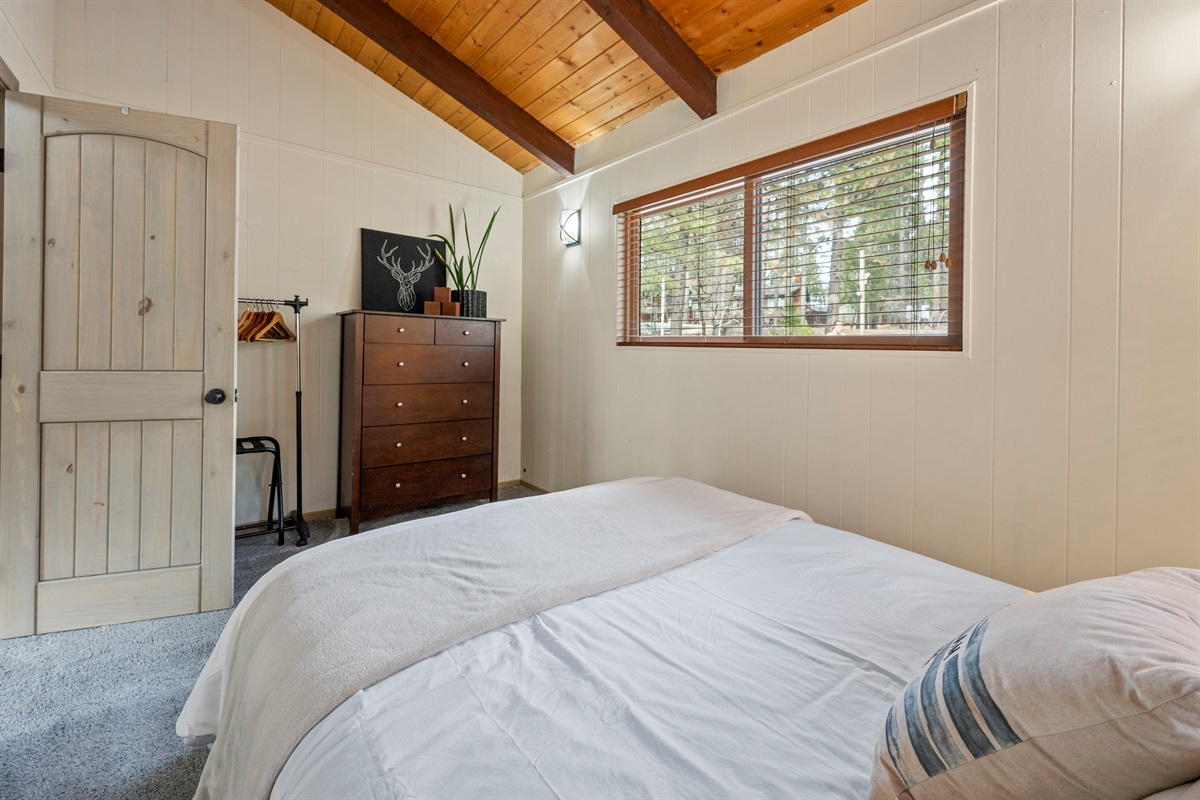 Clothes rack, extra hooks and a luggage rack peak out from behind the door.
