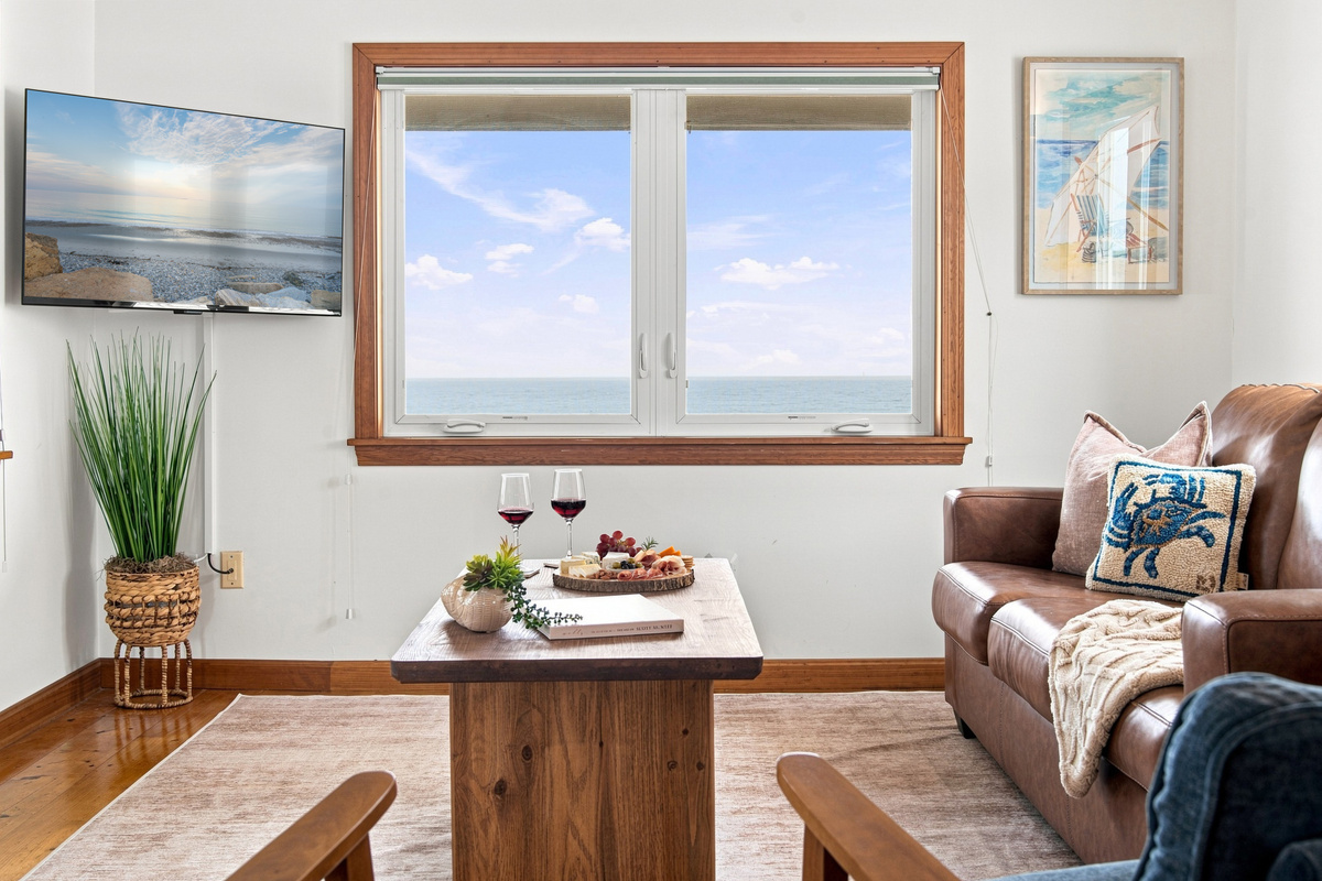 Relax in the inviting living area while taking in stunning water views from the large windows.