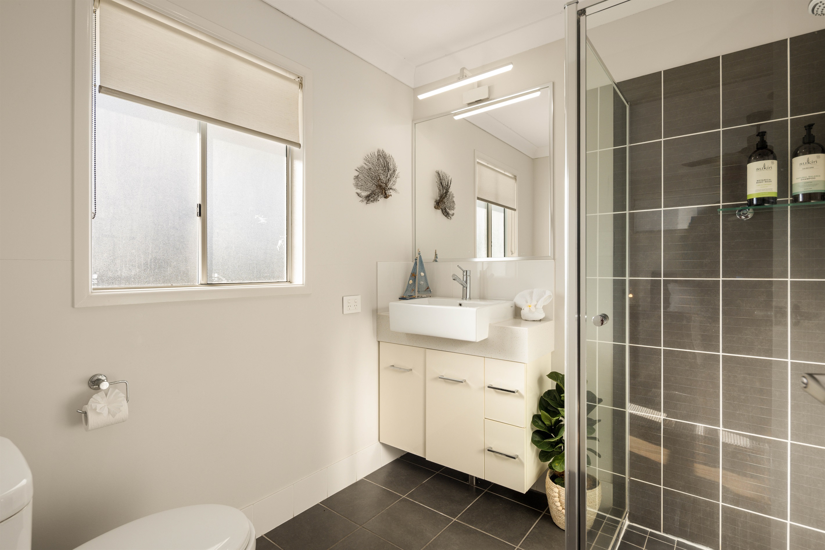 Private ensuite with shower and modern finishes.