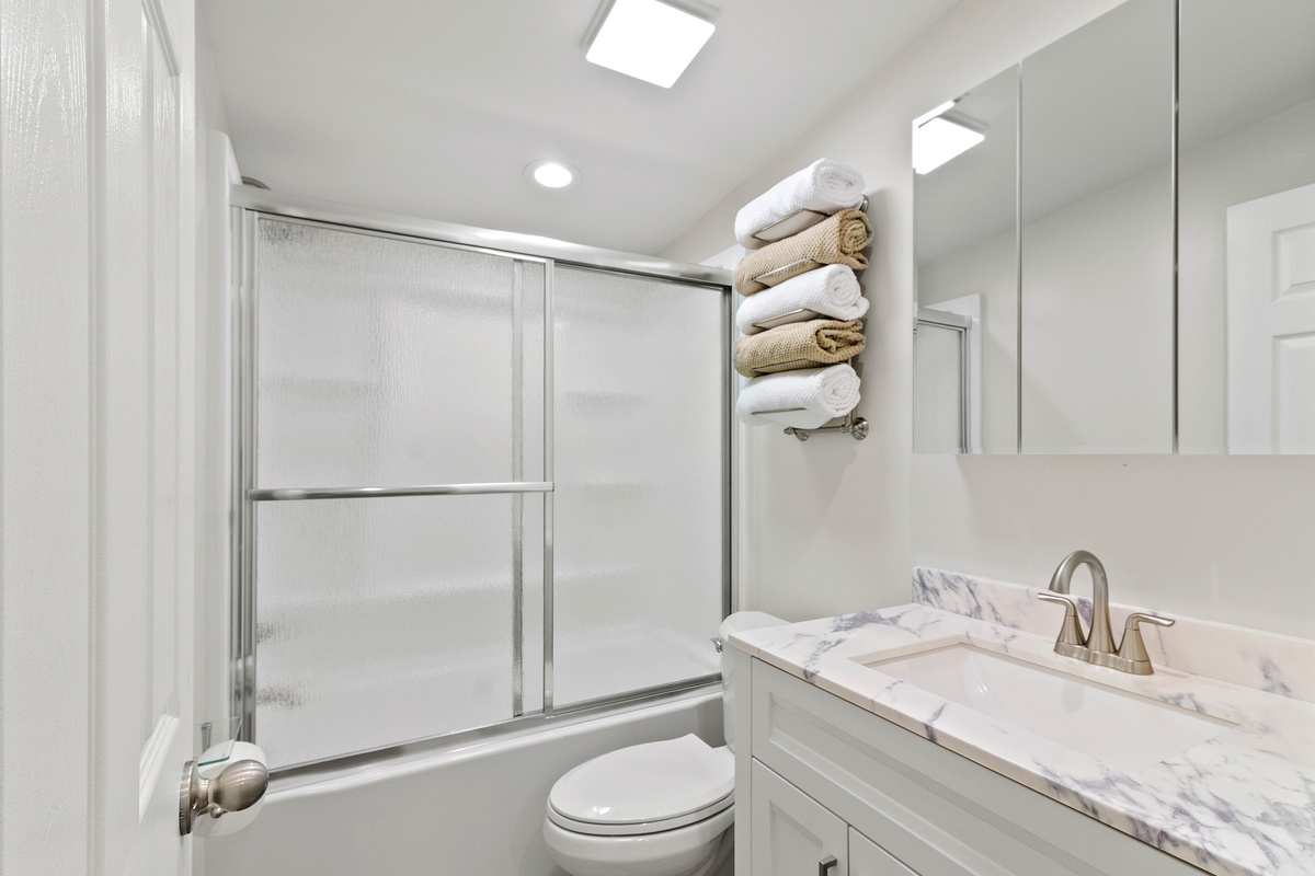The Waterbury Way - Secondary Bath with tub/shower combo and rainfall shower door