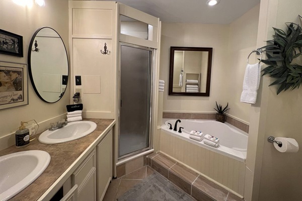 Master bathroom with Jacuzzi tub, walk-in shower, and double vanity.