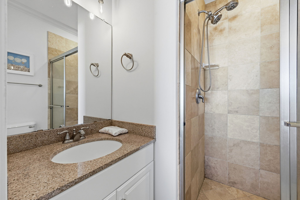 Clean and simple coastal bathroom designed for easy refreshing after long beach days