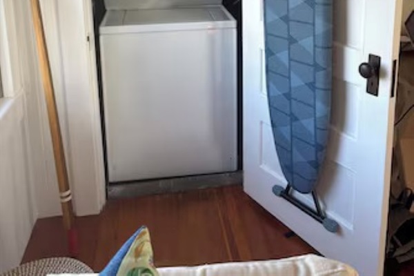 Keep your wardrobe fresh with a washer, dryer, and handy ironing board.