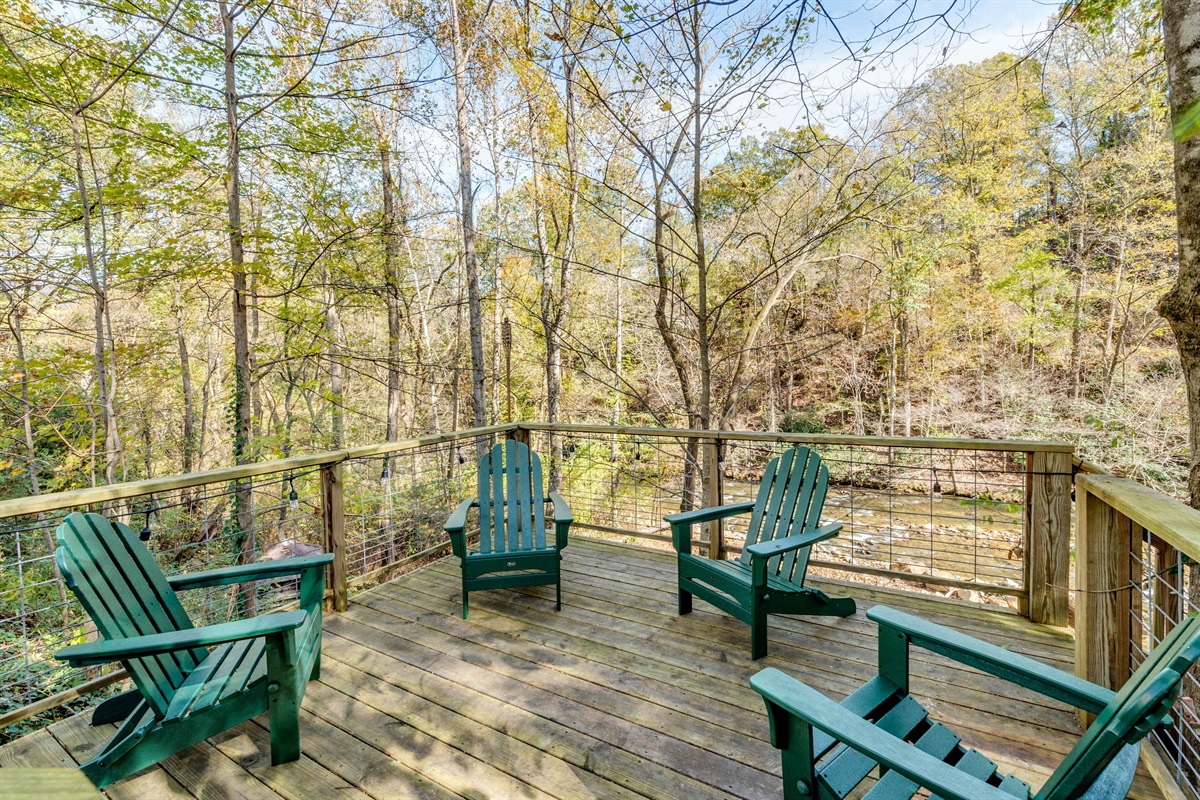 This sitting deck is perched above the creek & has steps to the recreation area